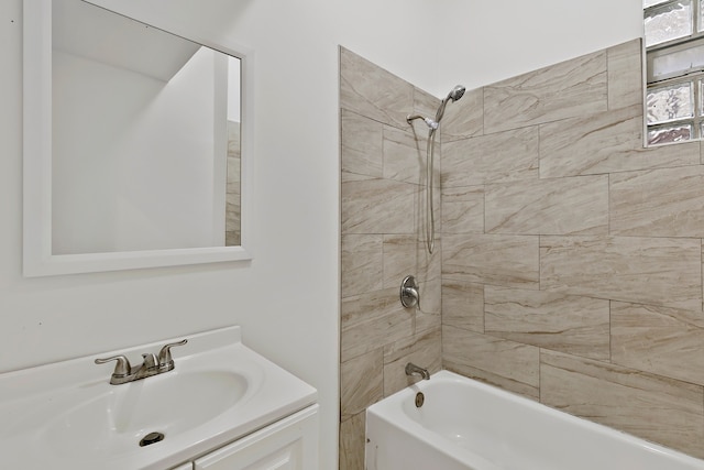 bathroom with tiled shower / bath combo and vanity