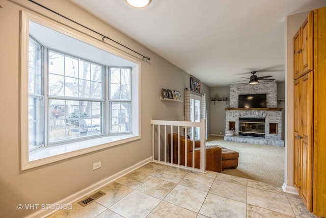 interior space featuring light tile patterned flooring, visible vents, and baseboards