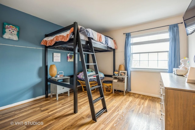 bedroom featuring light wood-style flooring and baseboards