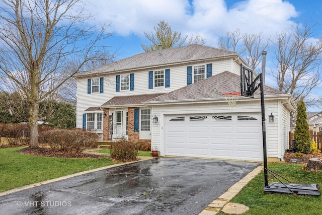 traditional-style house featuring a garage, a shingled roof, aphalt driveway, a front lawn, and brick siding