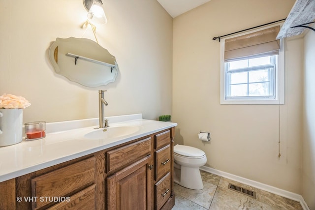 bathroom featuring toilet, baseboards, visible vents, and vanity