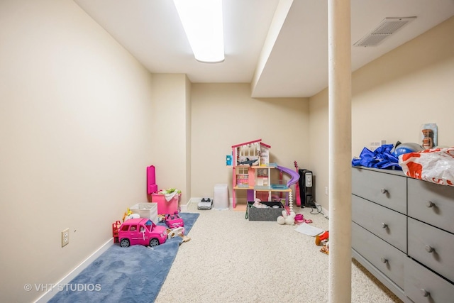 recreation room featuring visible vents and baseboards