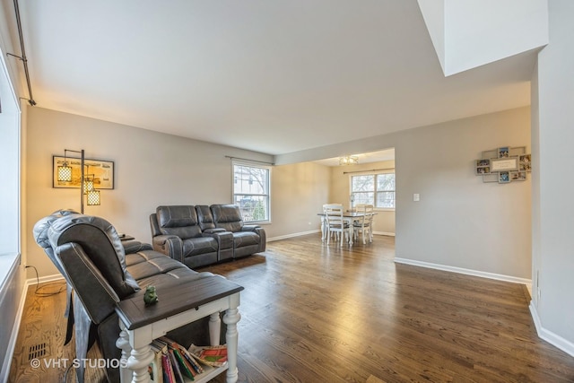 living room with baseboards and wood finished floors