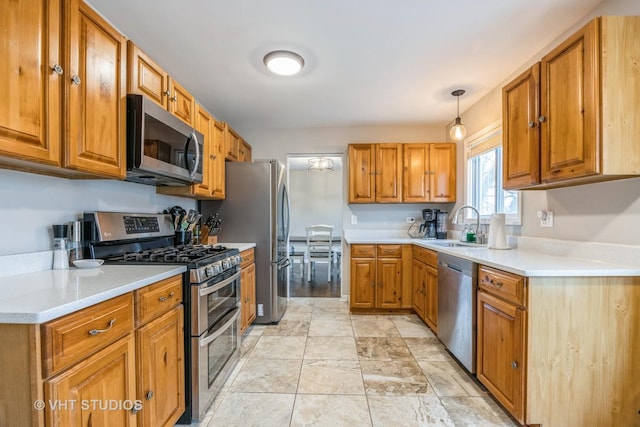 kitchen with stainless steel appliances, brown cabinetry, and a sink