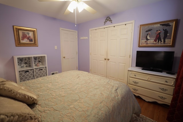 bedroom with dark hardwood / wood-style floors, ceiling fan, and a closet