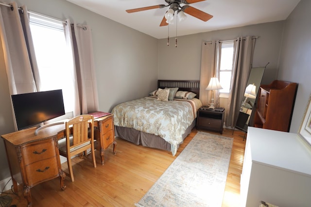 bedroom with light hardwood / wood-style floors and ceiling fan