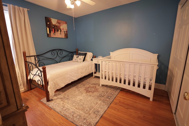 bedroom featuring hardwood / wood-style flooring and ceiling fan