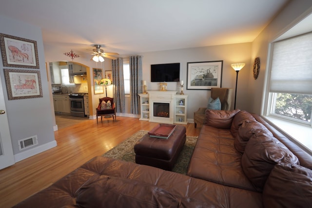 living room featuring light hardwood / wood-style floors and ceiling fan