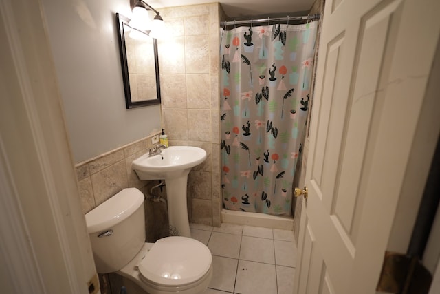 bathroom with sink, tile walls, tile patterned floors, toilet, and walk in shower