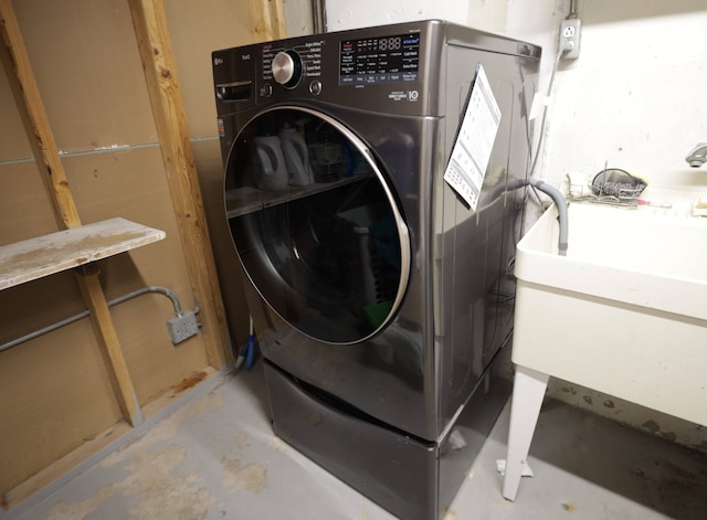 laundry room featuring sink and washer / dryer