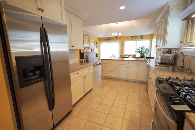 kitchen featuring sink, tasteful backsplash, hanging light fixtures, light tile patterned floors, and appliances with stainless steel finishes