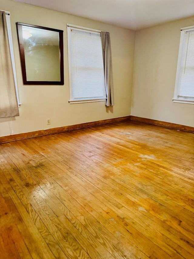 unfurnished room with light wood-type flooring