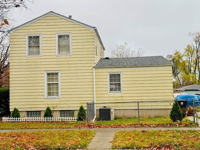 view of side of home with central air condition unit