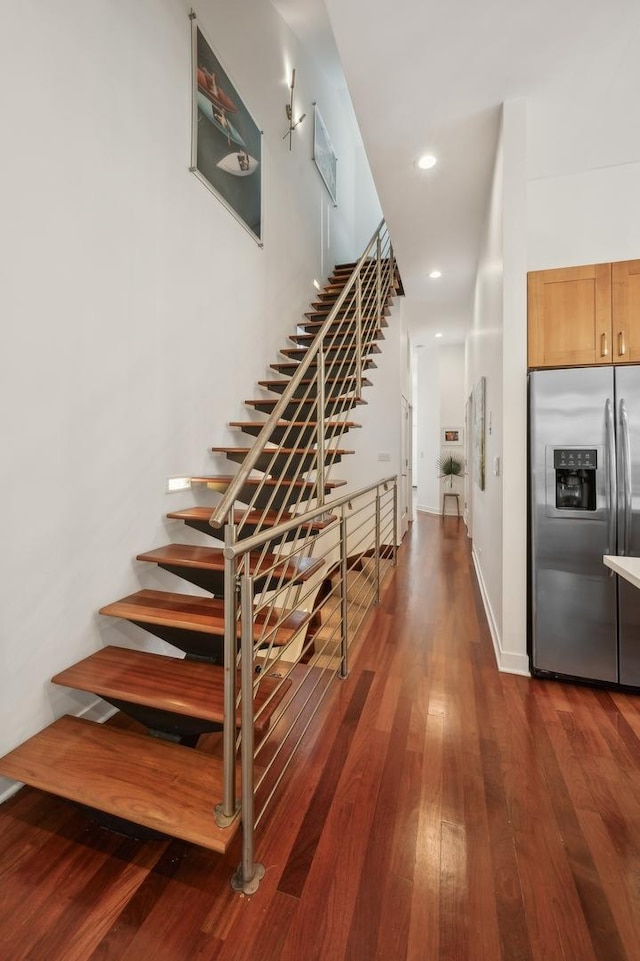 stairway with hardwood / wood-style floors