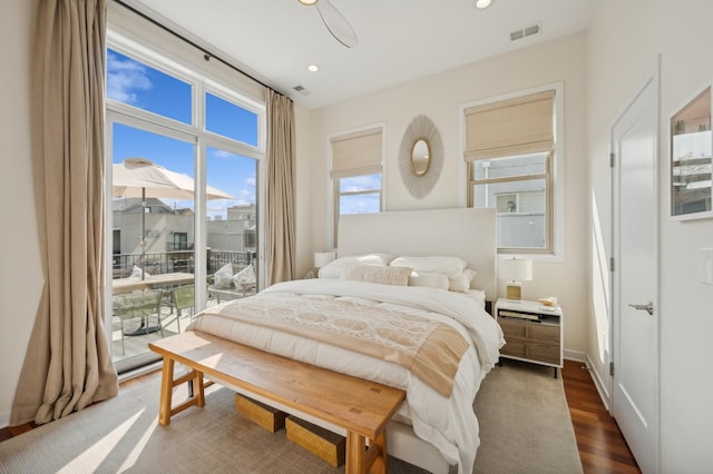 bedroom featuring dark wood-type flooring and access to outside