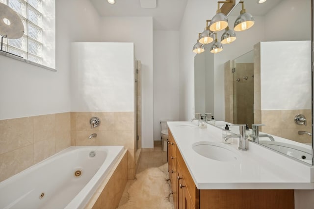 full bathroom with independent shower and bath, vanity, tile patterned floors, and toilet