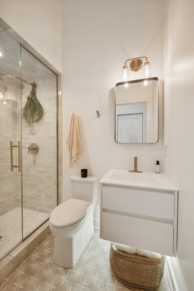 bathroom with vanity, toilet, and an enclosed shower