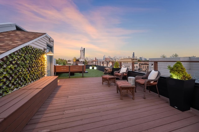 deck at dusk featuring an outdoor hangout area