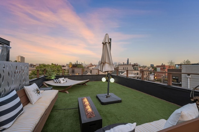 yard at dusk featuring an outdoor living space with a fire pit