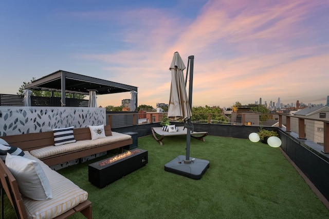 yard at dusk with an outdoor living space with a fire pit