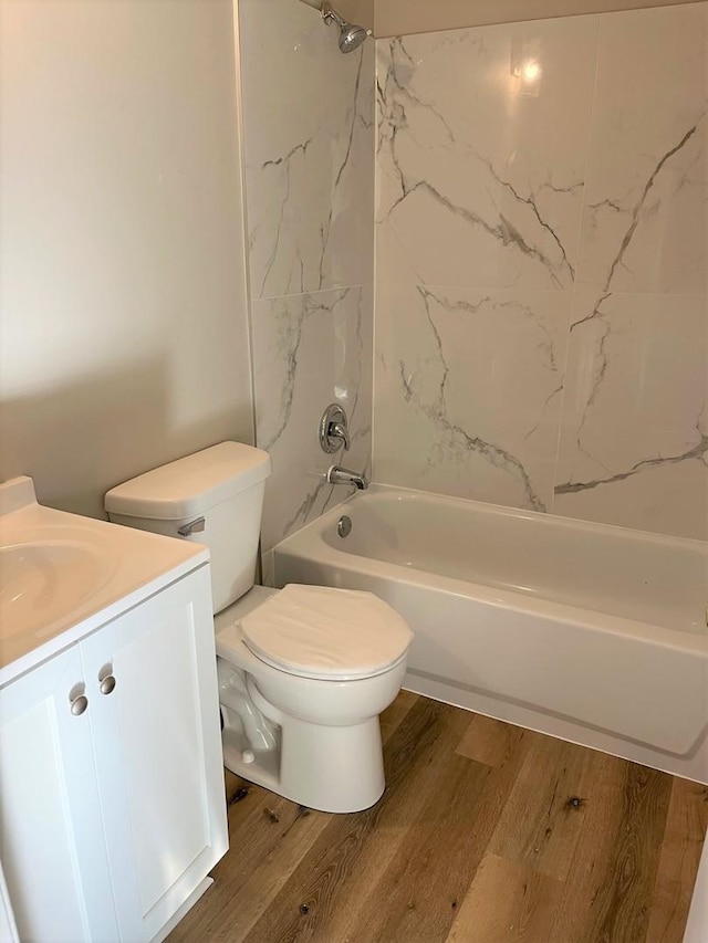 full bathroom with shower / tub combination, vanity, toilet, and wood-type flooring