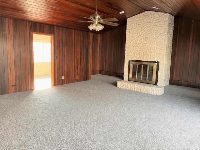 unfurnished living room featuring wooden walls, wooden ceiling, and a fireplace