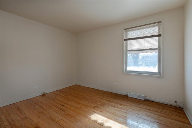 spare room featuring light hardwood / wood-style flooring