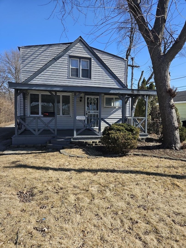 view of front of property with covered porch and a front lawn