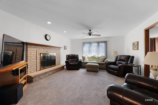 living room with a brick fireplace, light carpet, and ceiling fan