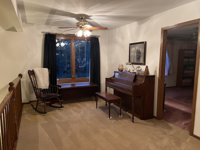 sitting room with ceiling fan and light carpet