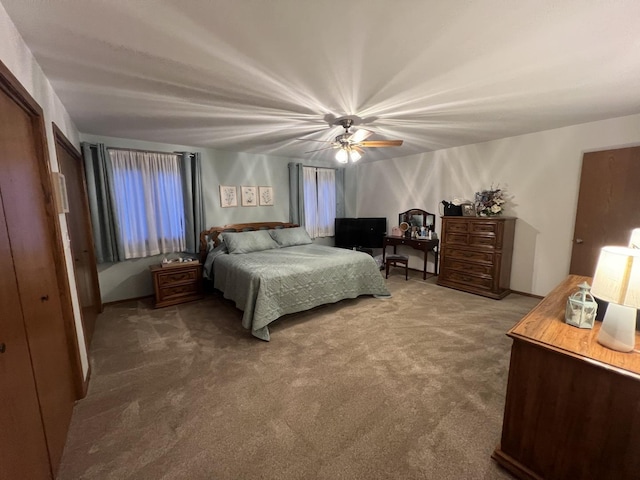 bedroom with carpet floors, ceiling fan, and a closet