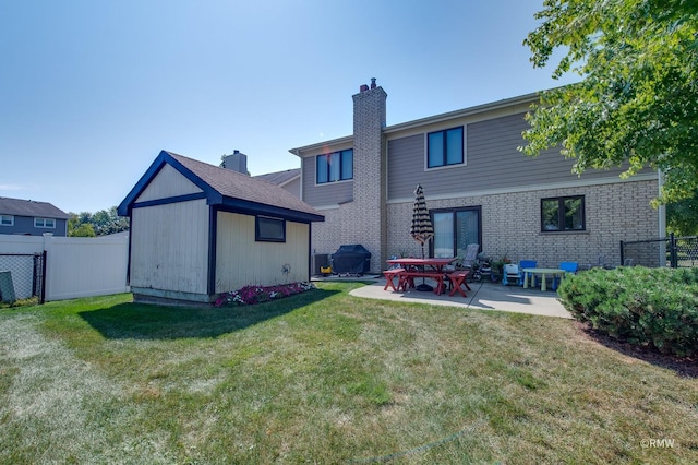 back of house featuring a lawn and a patio area