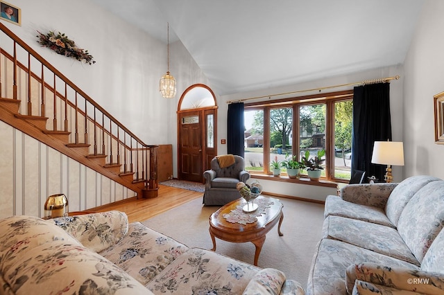 living room with light hardwood / wood-style flooring and a notable chandelier