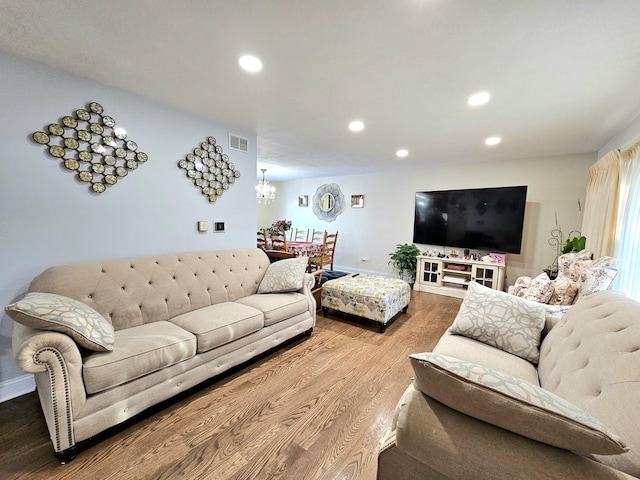 living room featuring hardwood / wood-style flooring and a notable chandelier