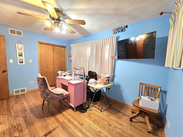 office space with ceiling fan and wood-type flooring