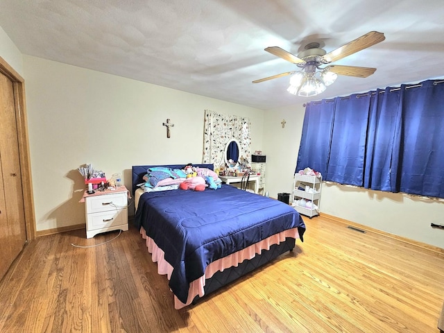 bedroom with wood-type flooring and ceiling fan