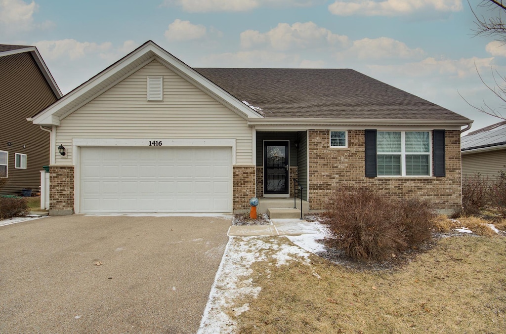 ranch-style house featuring a garage