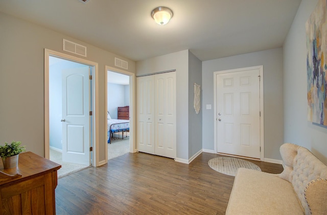 entryway with dark hardwood / wood-style flooring