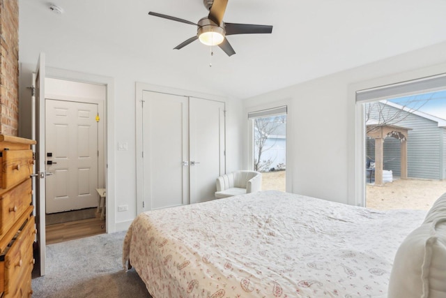 carpeted bedroom featuring ceiling fan and a closet