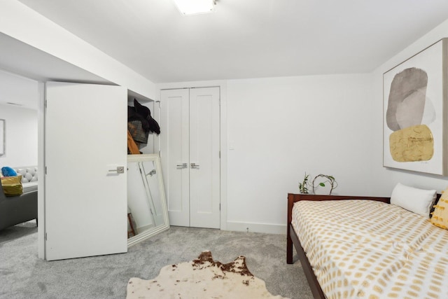 bedroom featuring light colored carpet and a closet