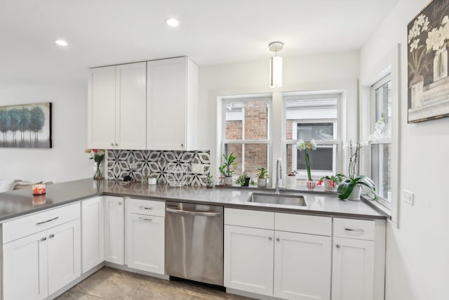 kitchen featuring sink, white cabinetry, tasteful backsplash, decorative light fixtures, and dishwasher