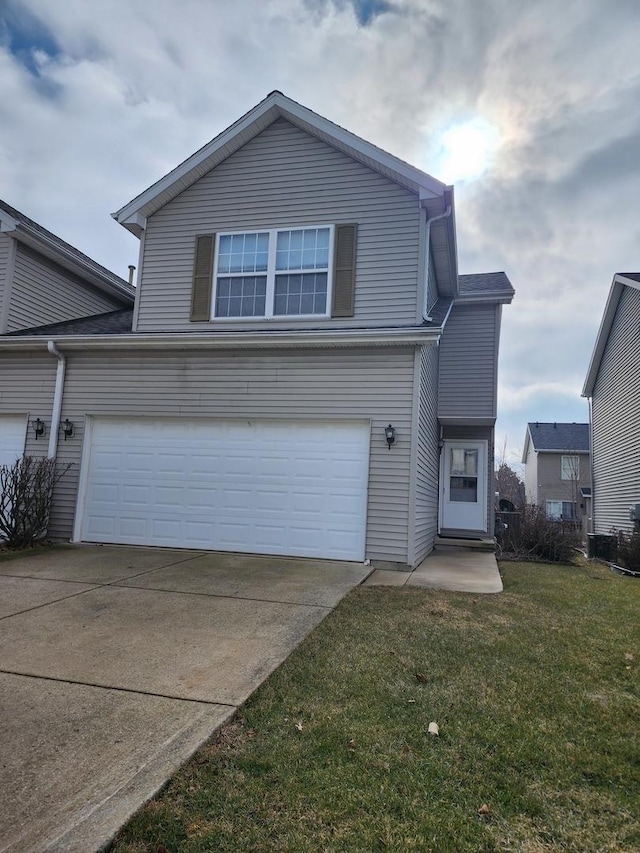 view of property with a garage and a front lawn