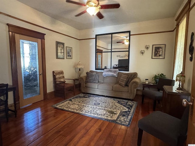 living room featuring ceiling fan and dark hardwood / wood-style flooring