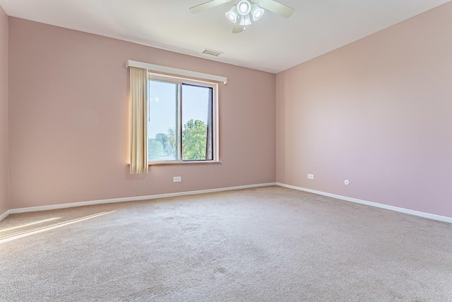 carpeted spare room featuring ceiling fan