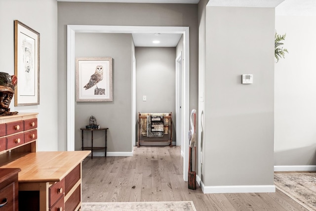 corridor with light hardwood / wood-style floors