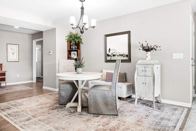 dining area with an inviting chandelier and hardwood / wood-style floors