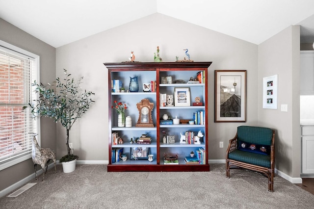 living area with lofted ceiling and carpet flooring