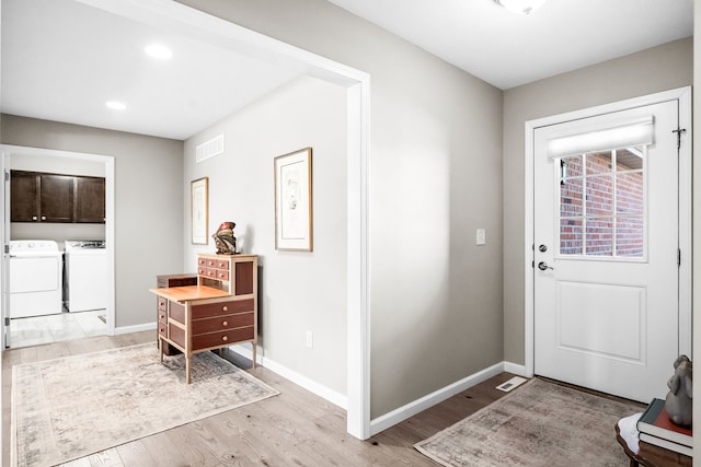 entryway featuring light hardwood / wood-style flooring and washer and clothes dryer