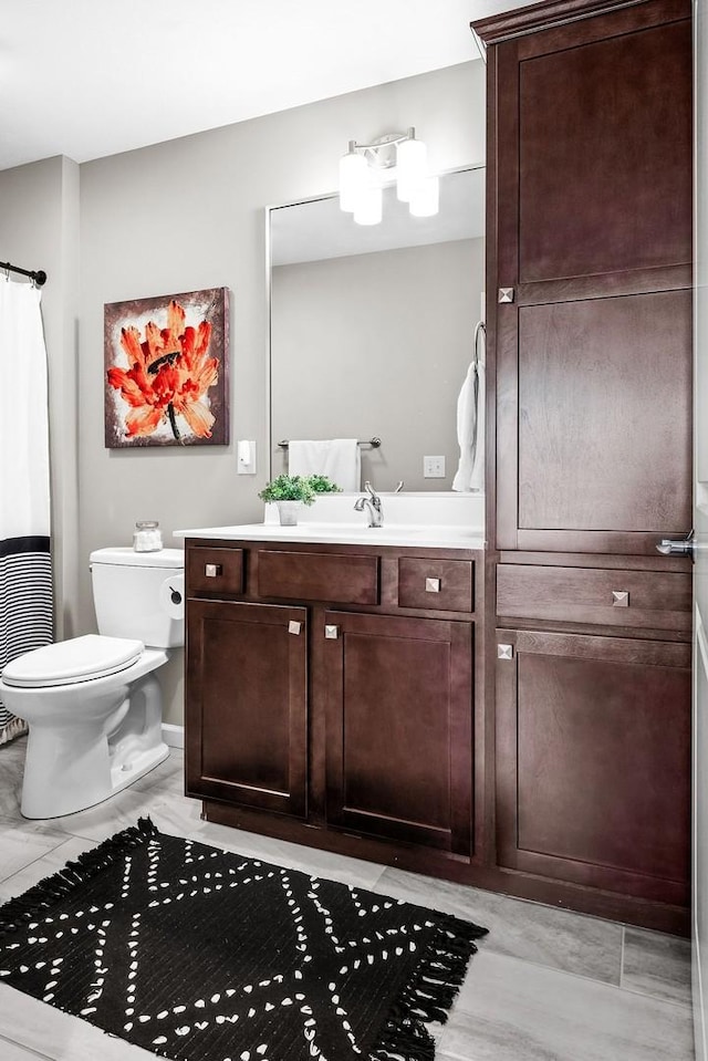 bathroom featuring vanity and toilet