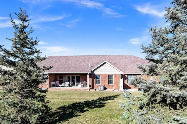 back of house featuring a yard, central AC, and a patio area